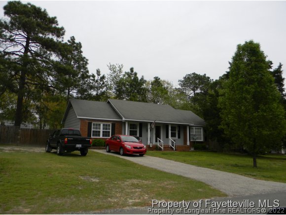 638 Azalea Drive Spring Lake, NC 28390 - Photo 2 of 14 a front view of a house with a garden and trees