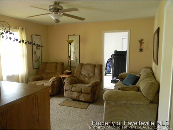 638 Azalea Drive Spring Lake, NC 28390 - Photo 3 of 14 a living room with furniture and a chandelier