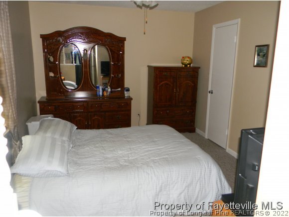 638 Azalea Drive Spring Lake, NC 28390 - Photo 8 of 14 a bedroom with a bed and a dresser