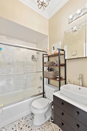 a bathroom with a sink a toilet and shower