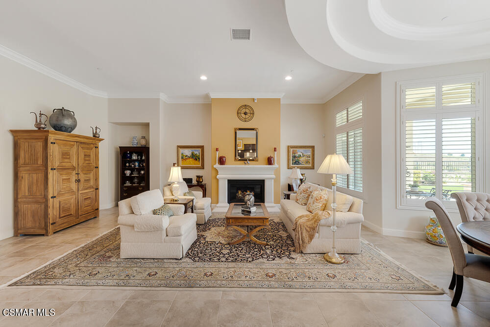 11290 Crenshaw Street Moorpark, CA 93021 - Photo 7 of 42 a living room with furniture a fireplace and a large window