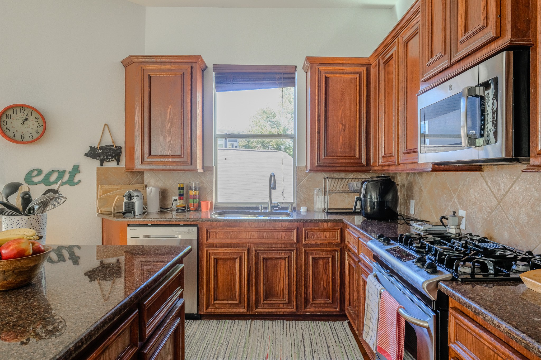 2609 Link Road Houston, TX 77009 - Photo 11 of 21 a kitchen with stainless steel appliances granite countertop a stove a sink dishwasher and cabinets with wooden floor
