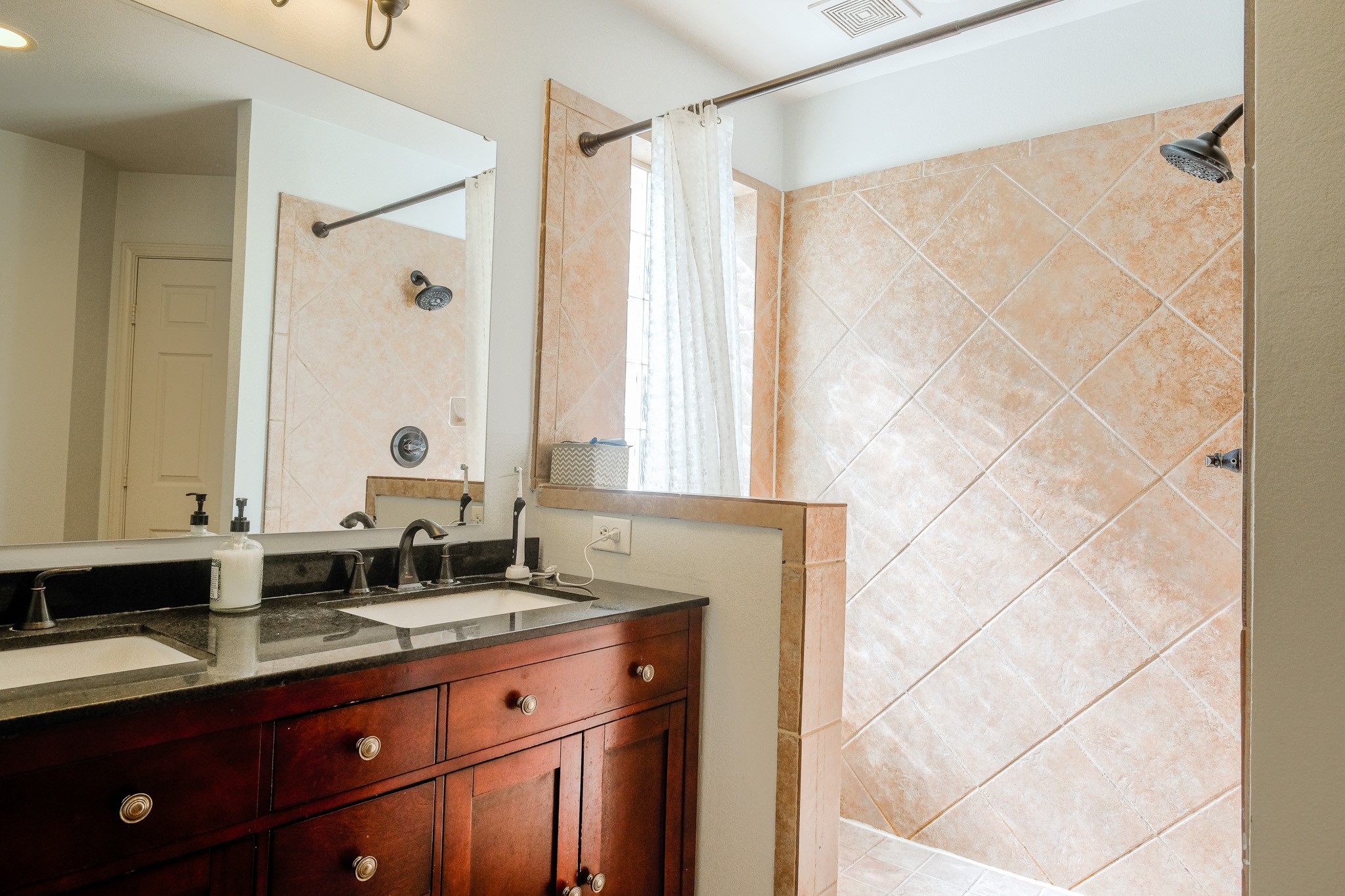 2609 Link Road Houston, TX 77009 - Photo 13 of 21 a bathroom with a double vanity sink and mirror