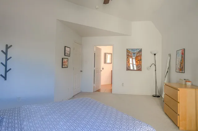 a bedroom with a bed and a dresser