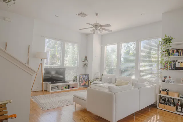 a living room with furniture and a wooden floor