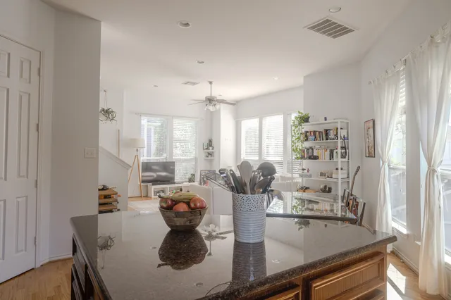 a kitchen with stainless steel appliances granite countertop a sink stove and cabinets