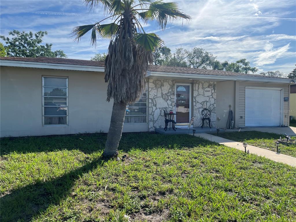 6345 Spring Hill Drive Spring Hill, FL 34606 - Photo 1 of 1 a house view with a garden space