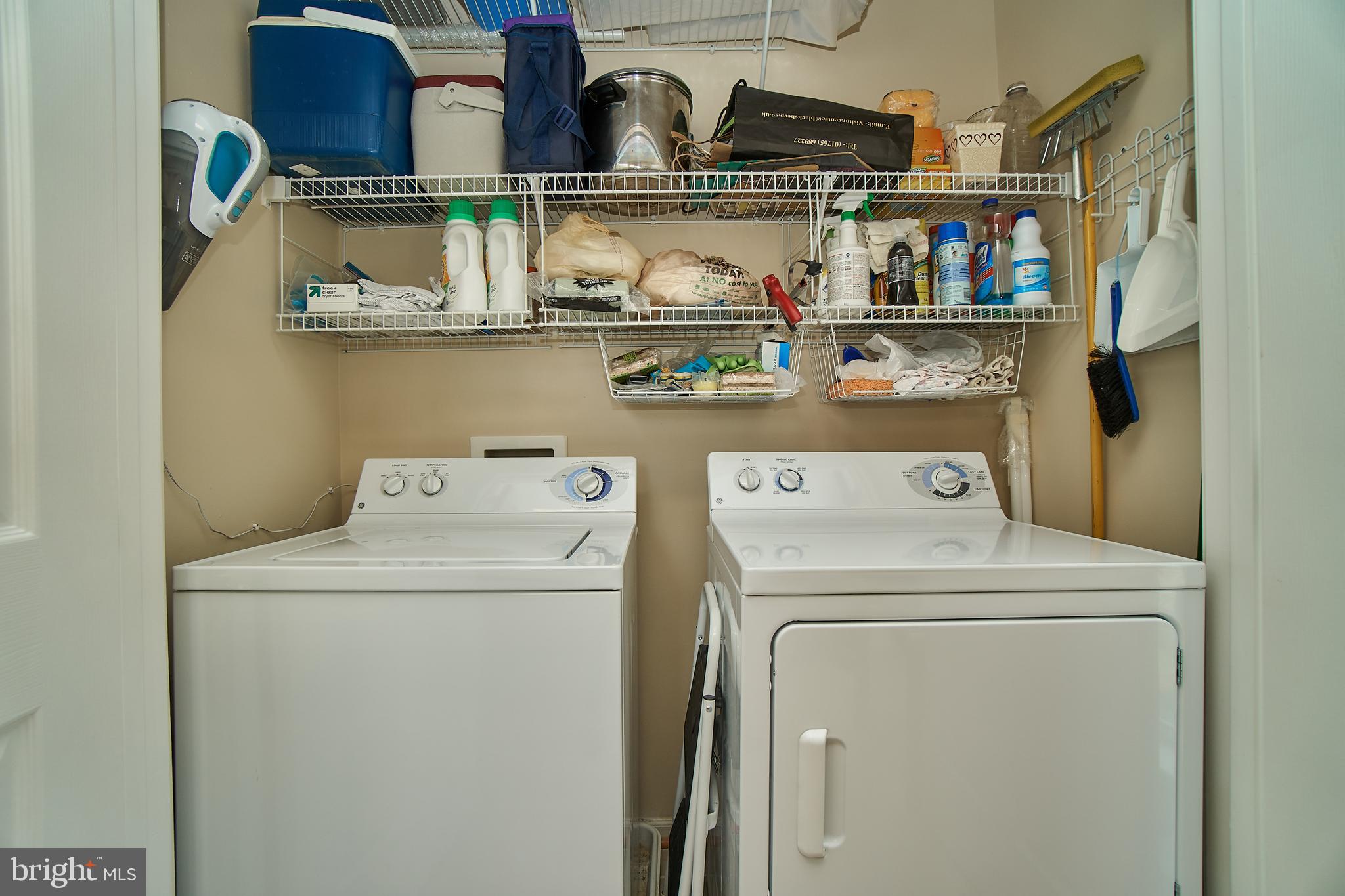 1520 North Point Drive, Unit 303 Reston, VA 20194 - Photo 21 of 29 Full-size washer and dryer in kitchen.