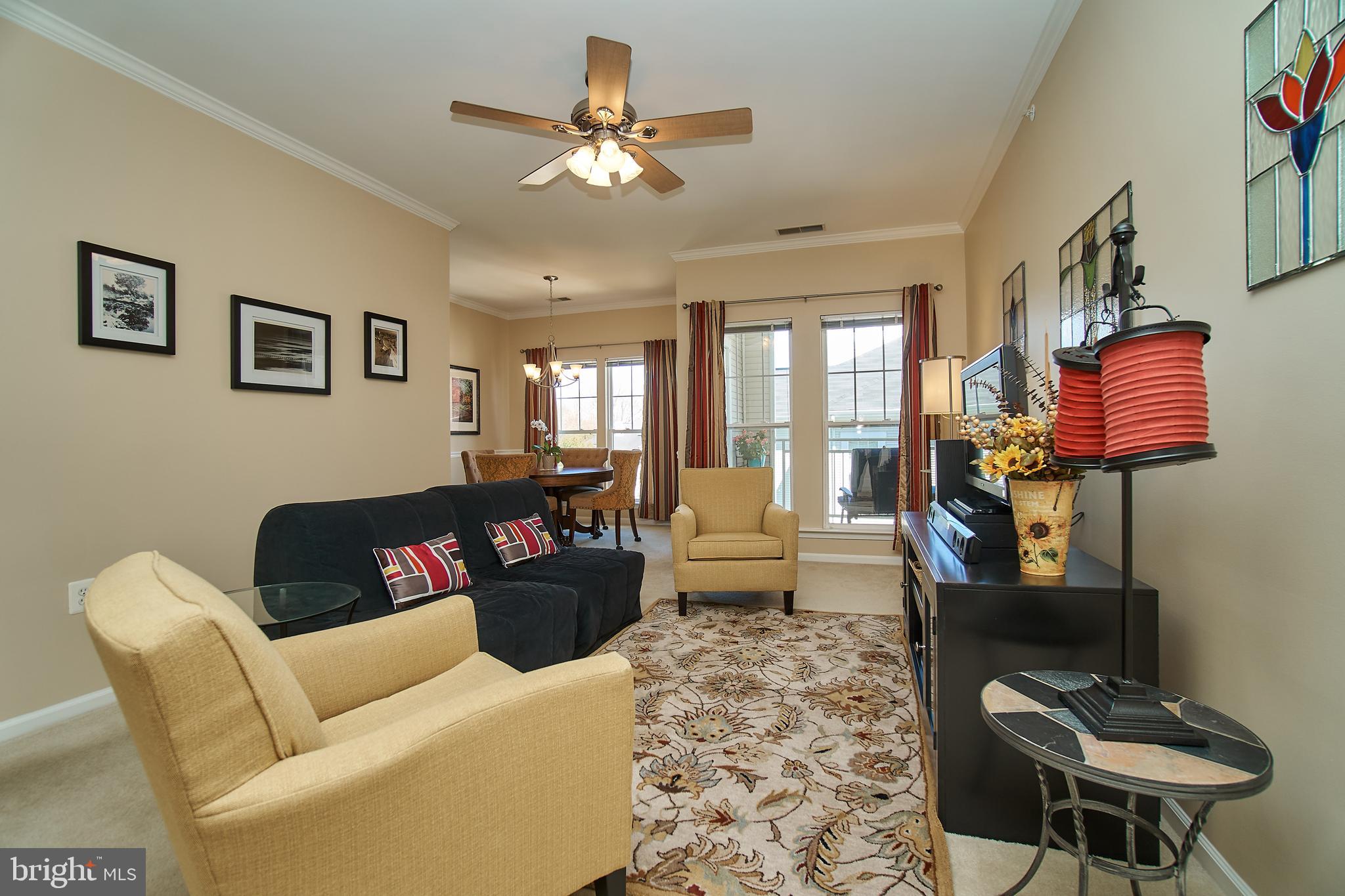 1520 North Point Drive, Unit 303 Reston, VA 20194 - Photo 4 of 29 Living room with view to balcony.