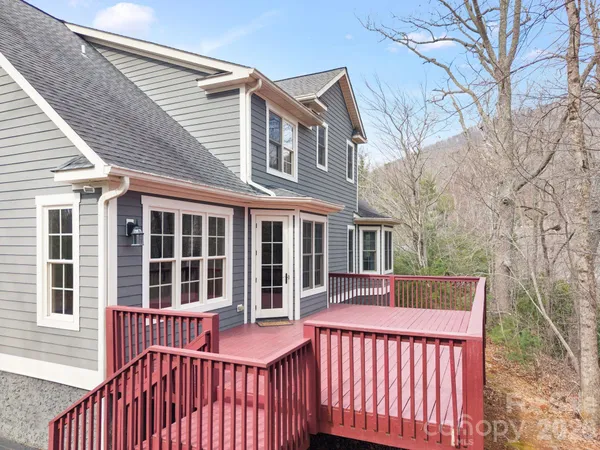 a view of a house with a wooden fence