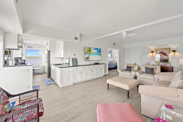 a kitchen with stainless steel appliances granite countertop a sink a stove and cabinets