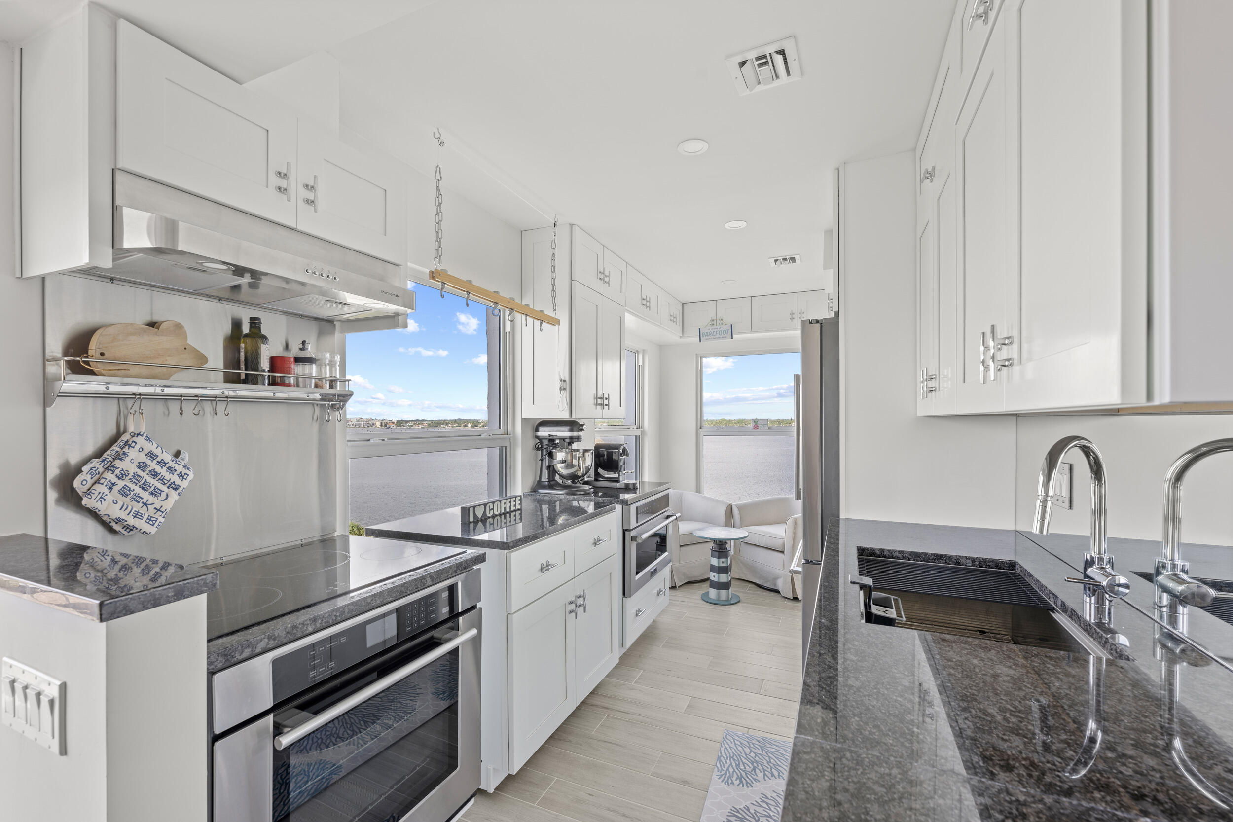 3230 South Ocean Boulevard, Unit A602 Palm Beach, FL 33480 - Photo 18 of 87 a kitchen with stainless steel appliances granite countertop a sink stove and refrigerator