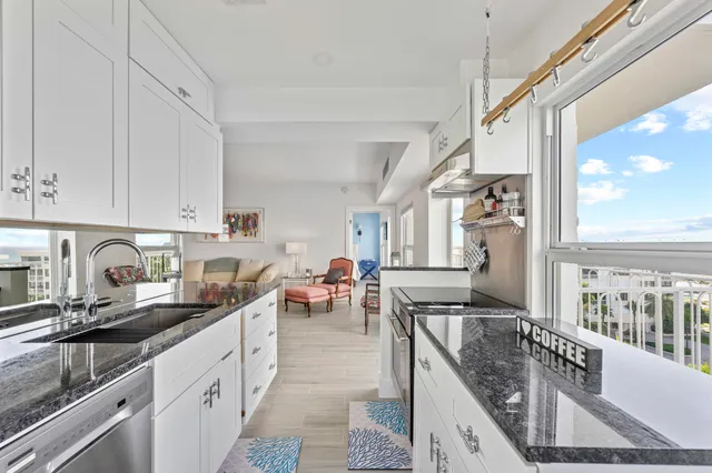 a bathroom with a granite countertop sink a toilet and shower