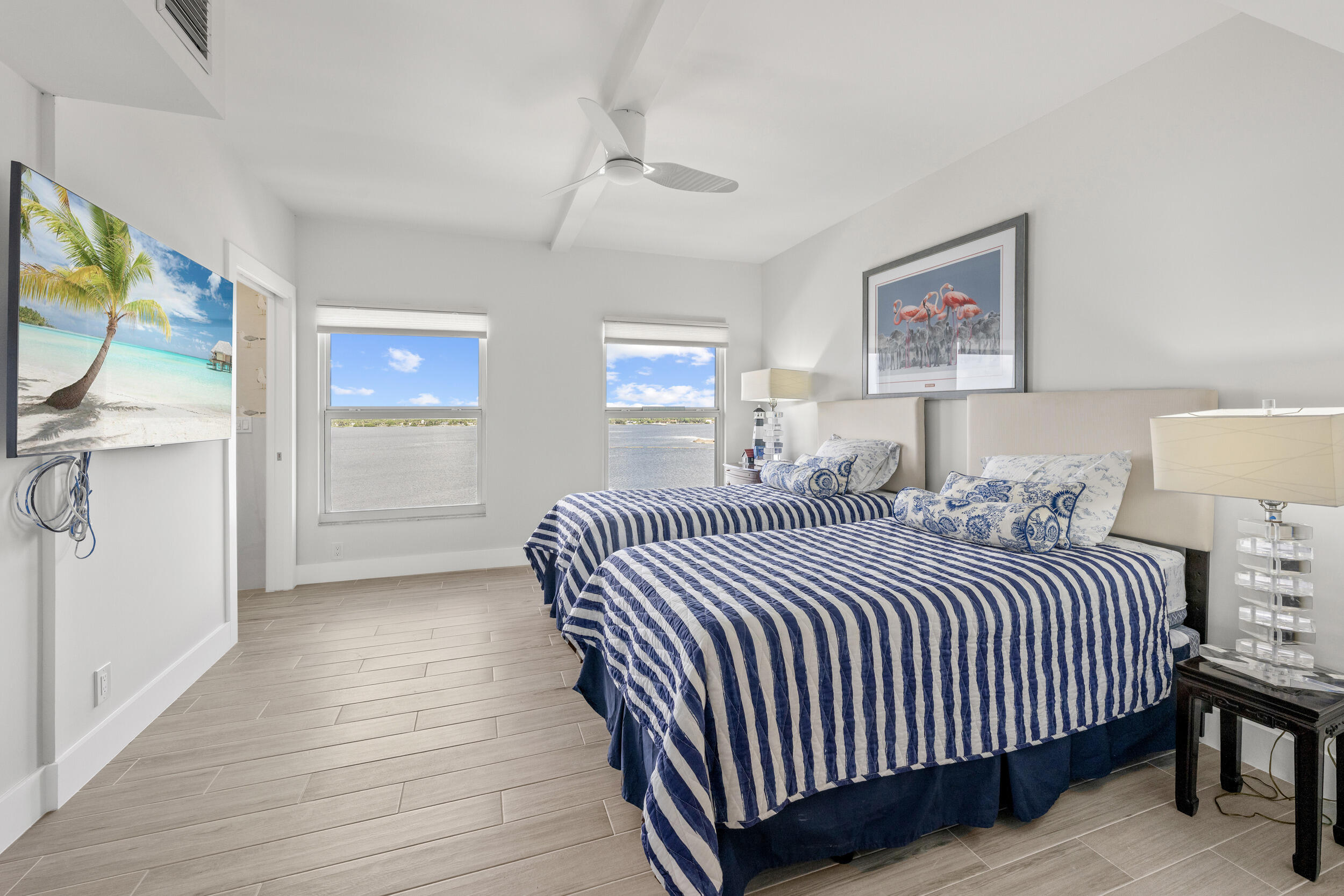 3230 South Ocean Boulevard, Unit A602 Palm Beach, FL 33480 - Photo 26 of 87 a bedroom with a bed and a painting on the wall