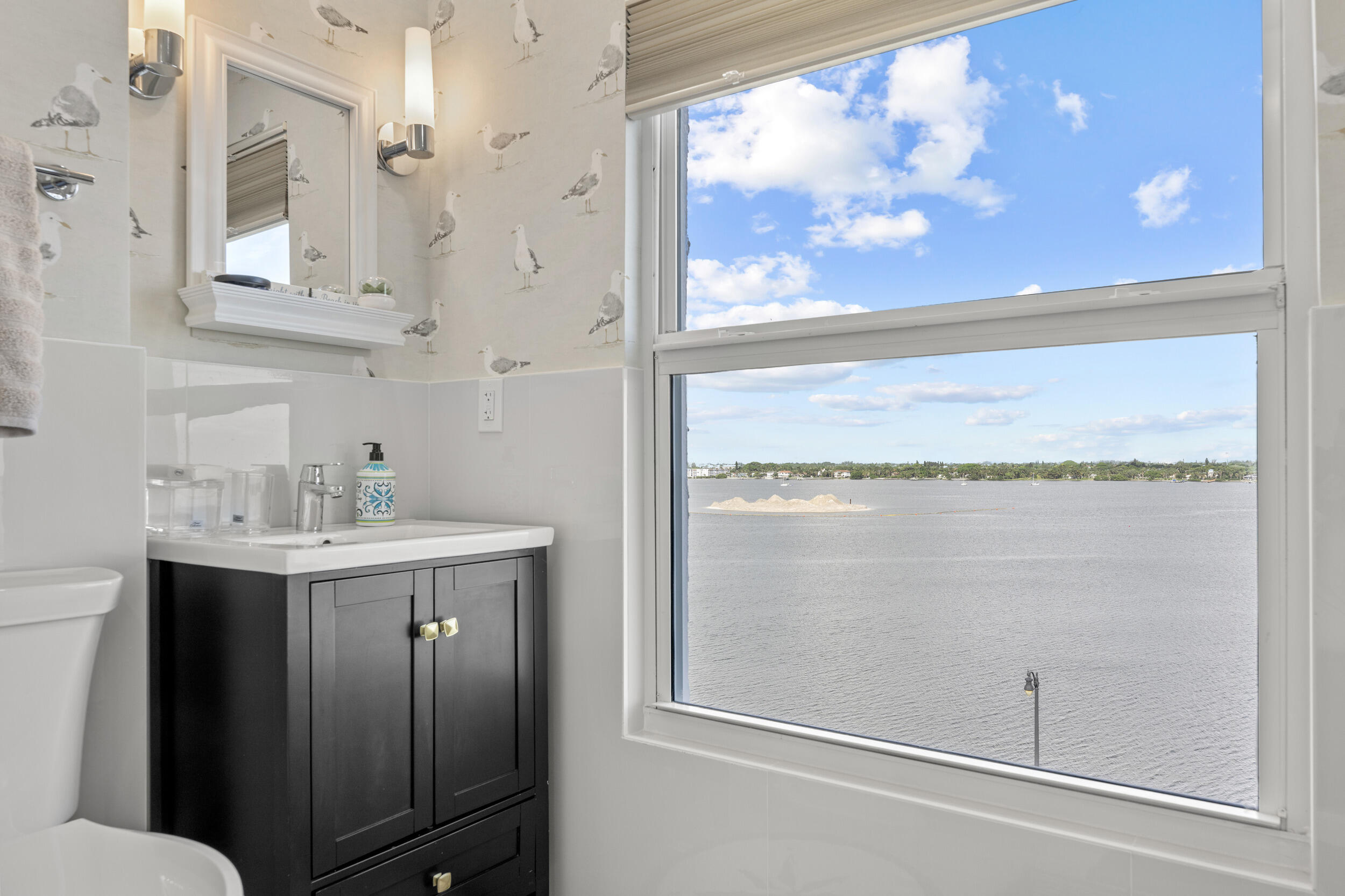 3230 South Ocean Boulevard, Unit A602 Palm Beach, FL 33480 - Photo 32 of 87 a bathroom with a granite countertop sink mirror and vanity