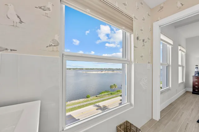 a living room with furniture a chandelier and a table