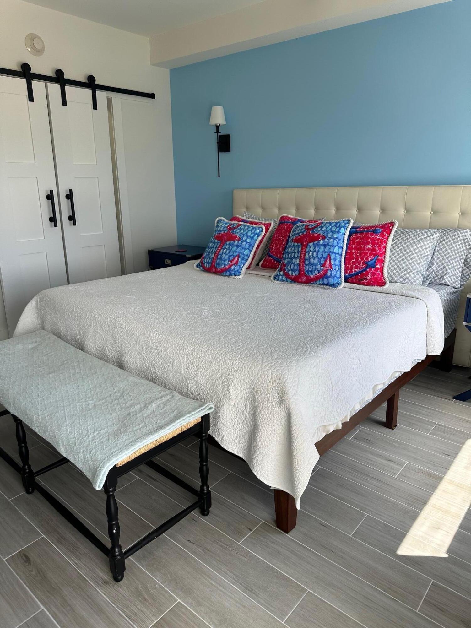 3230 South Ocean Boulevard, Unit A602 Palm Beach, FL 33480 - Photo 39 of 87 a bedroom with a bed and a night stand