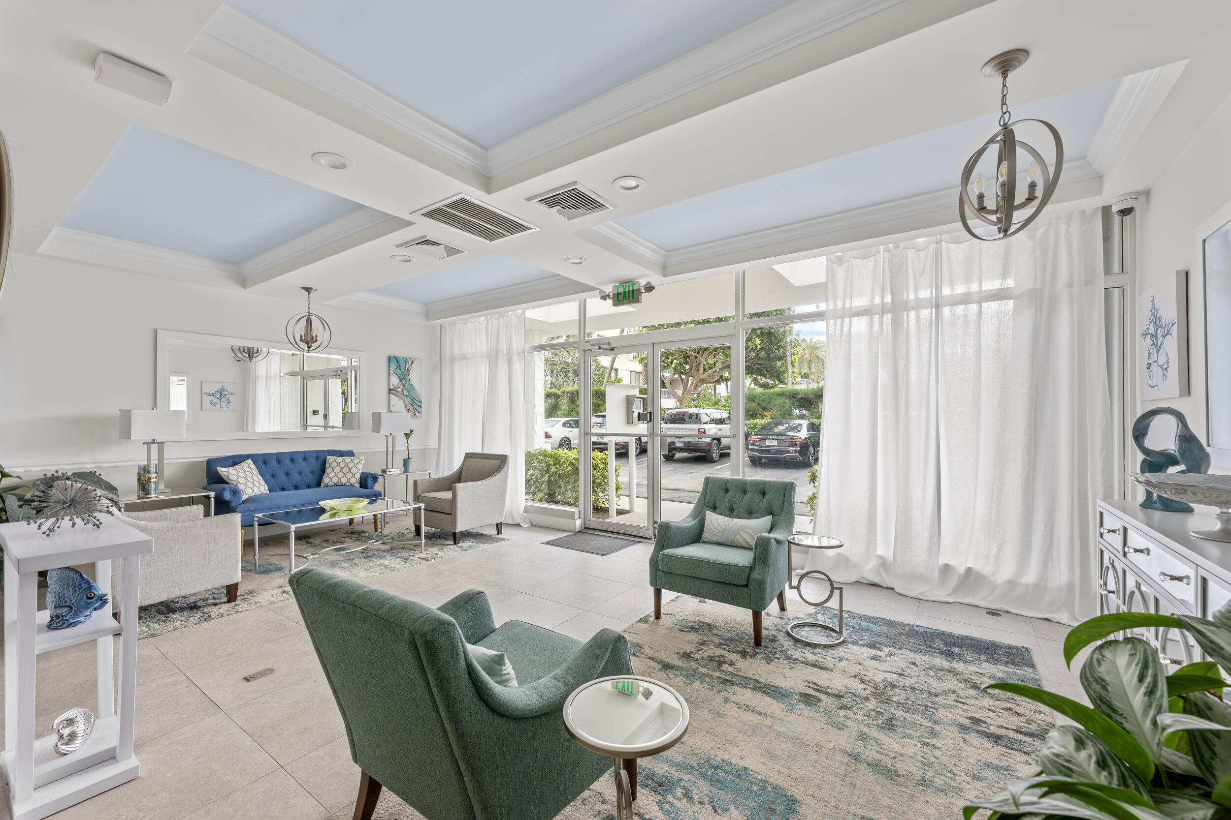 3230 South Ocean Boulevard, Unit A602 Palm Beach, FL 33480 - Photo 49 of 87 a living room with furniture a chandelier and a table