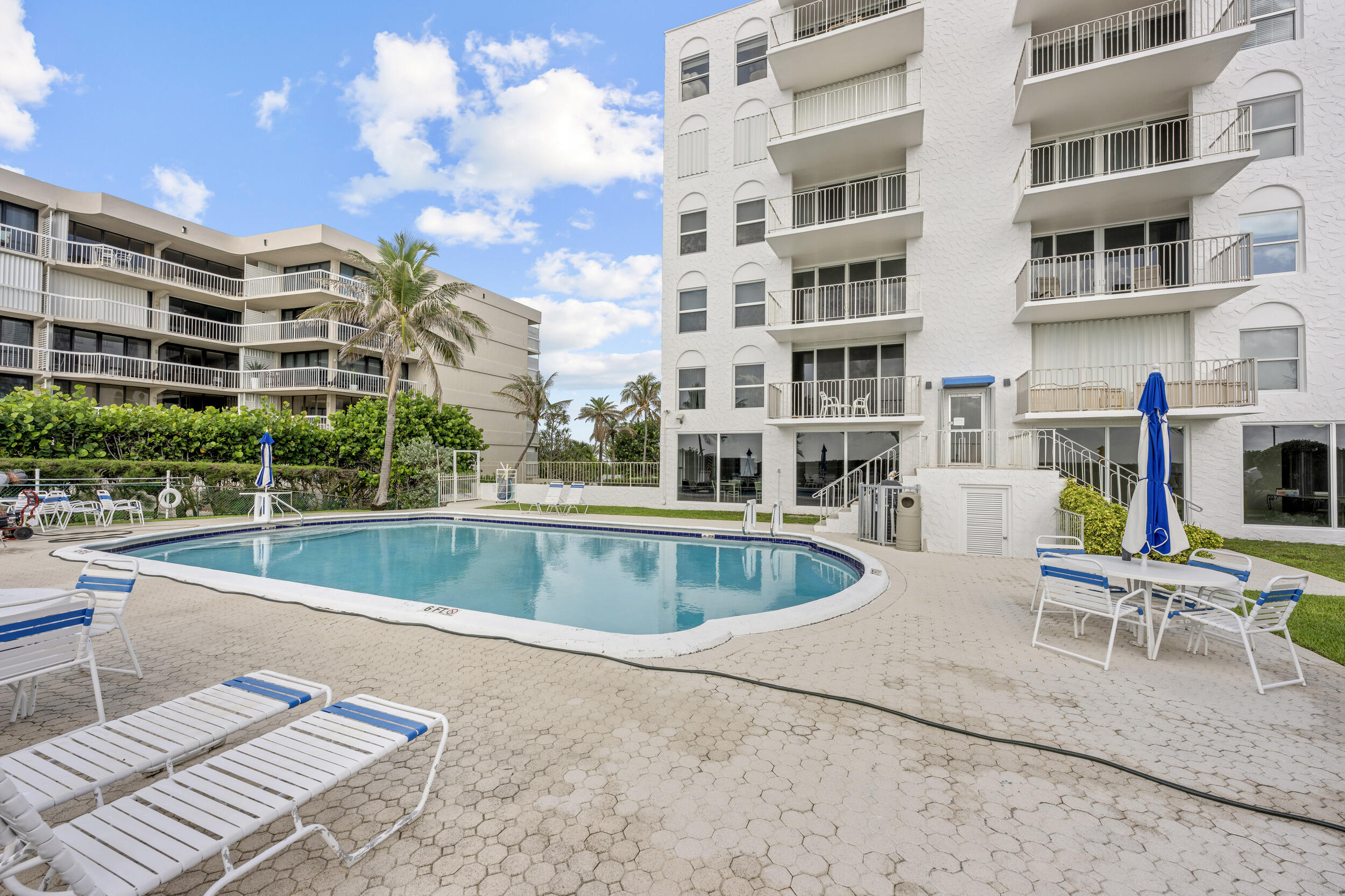 3230 South Ocean Boulevard, Unit A602 Palm Beach, FL 33480 - Photo 52 of 87 a view of a building with a swimming pool and sitting area