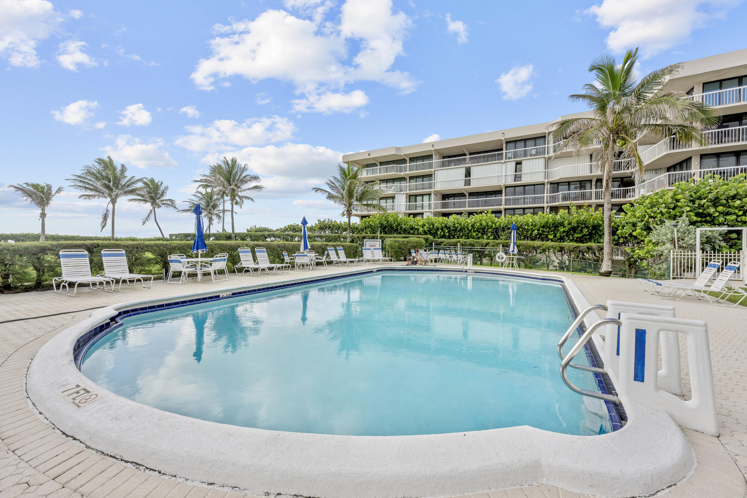 3230 South Ocean Boulevard, Unit A602 Palm Beach, FL 33480 - Photo 53 of 87 a view of a swimming pool with a patio
