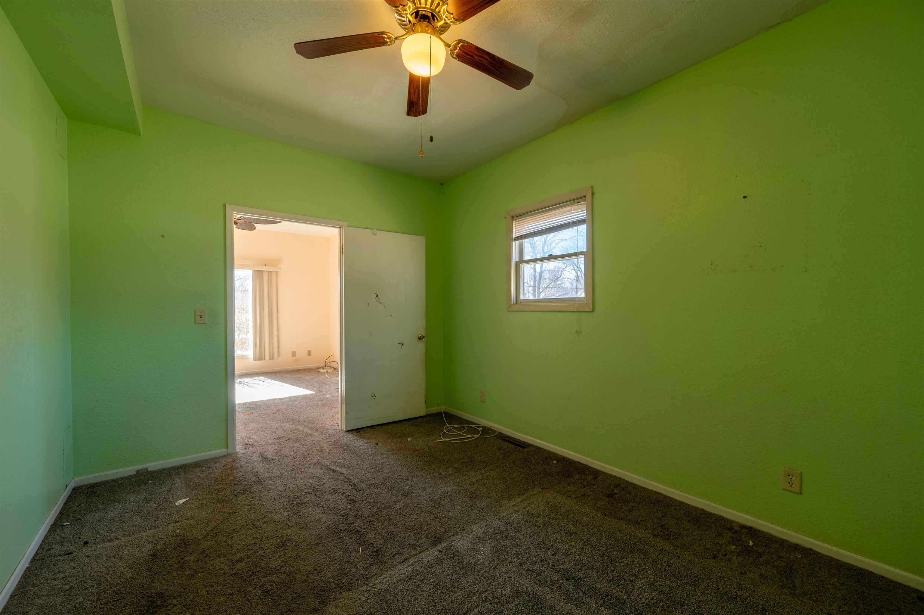 502 East Brayton Road Mount Morris, IL 61054 - Photo 8 of 19 a view of an empty room with window and chandelier fan