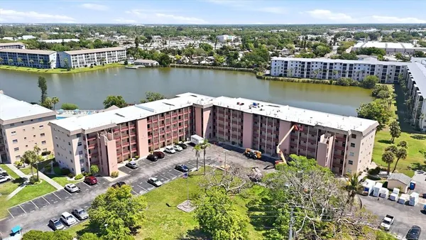 an aerial view of a house with a lake view