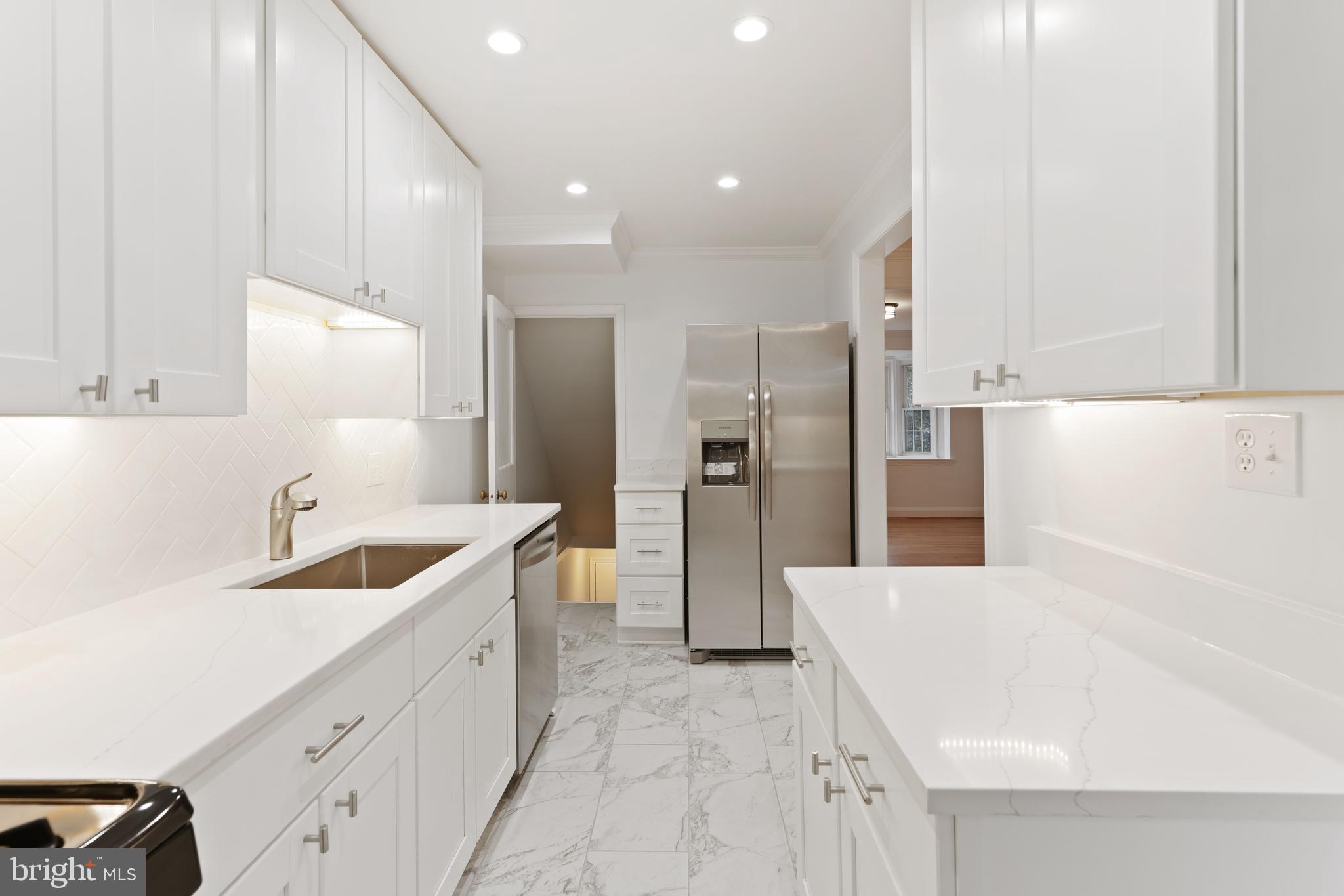 1667 Hardwick Road Towson, MD 21286 - Photo 11 of 34 a kitchen with a sink a refrigerator and cabinets