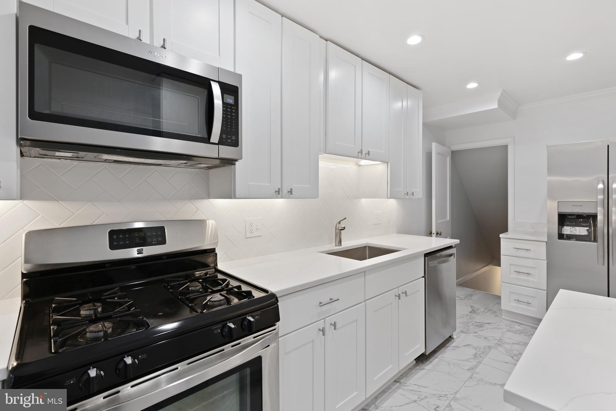 1667 Hardwick Road Towson, MD 21286 - Photo 12 of 34 a kitchen with a stove and a microwave
