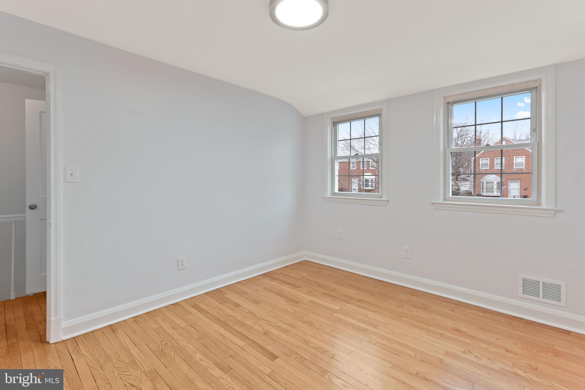 1667 Hardwick Road Towson, MD 21286 - Photo 18 of 34 an empty room with wooden floor and windows