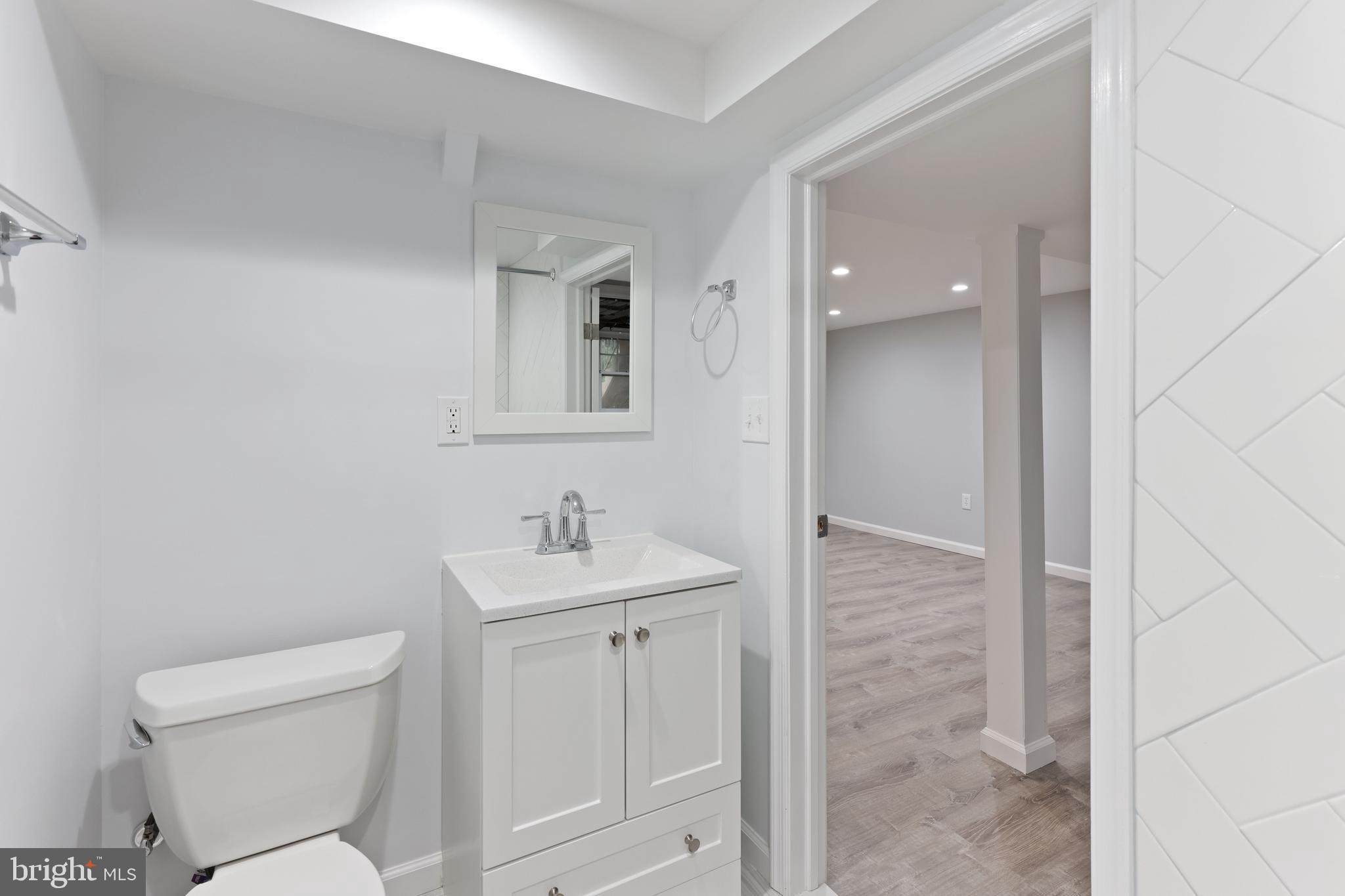 1667 Hardwick Road Towson, MD 21286 - Photo 26 of 34 a bathroom with a toilet a sink and mirror