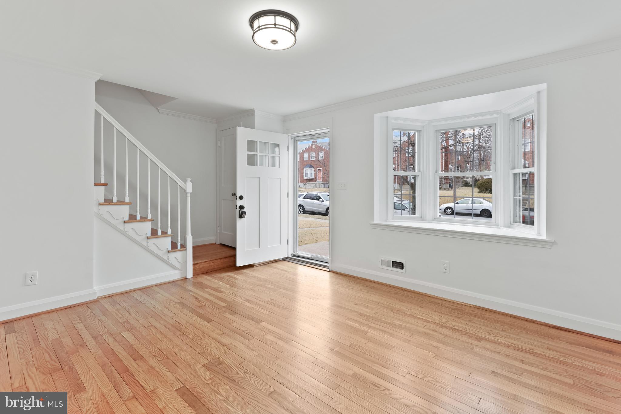1667 Hardwick Road Towson, MD 21286 - Photo 3 of 34 a view of an empty room with wooden floor and a window