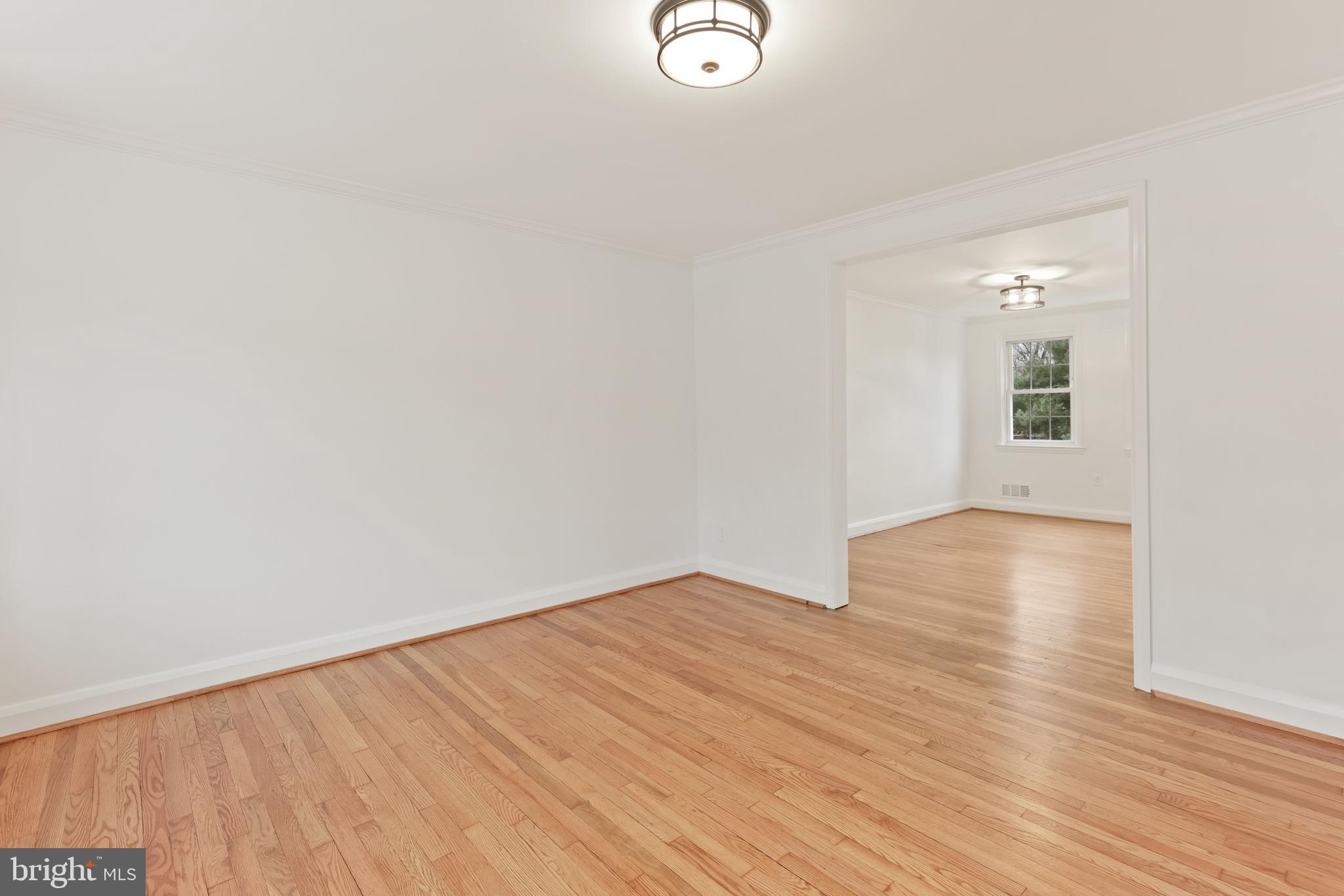 1667 Hardwick Road Towson, MD 21286 - Photo 5 of 34 an empty room with wooden floor and windows