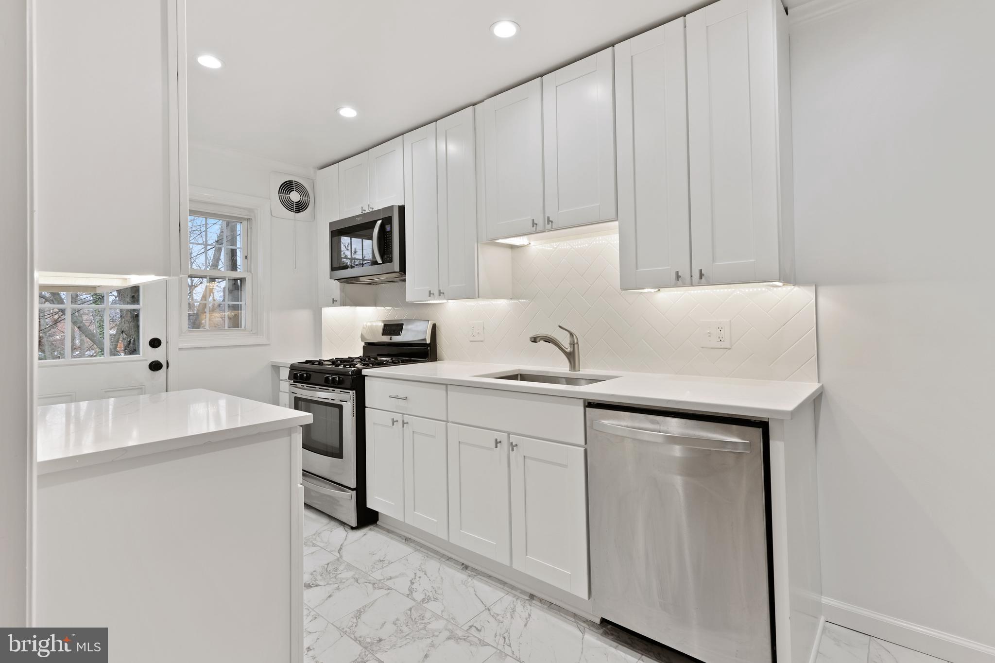 1667 Hardwick Road Towson, MD 21286 - Photo 10 of 34 a kitchen with sink a microwave and cabinets