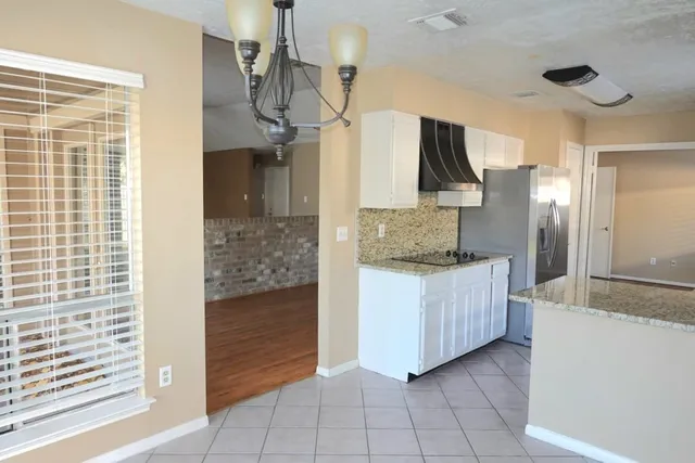 a bathroom with a granite countertop sink and a shower