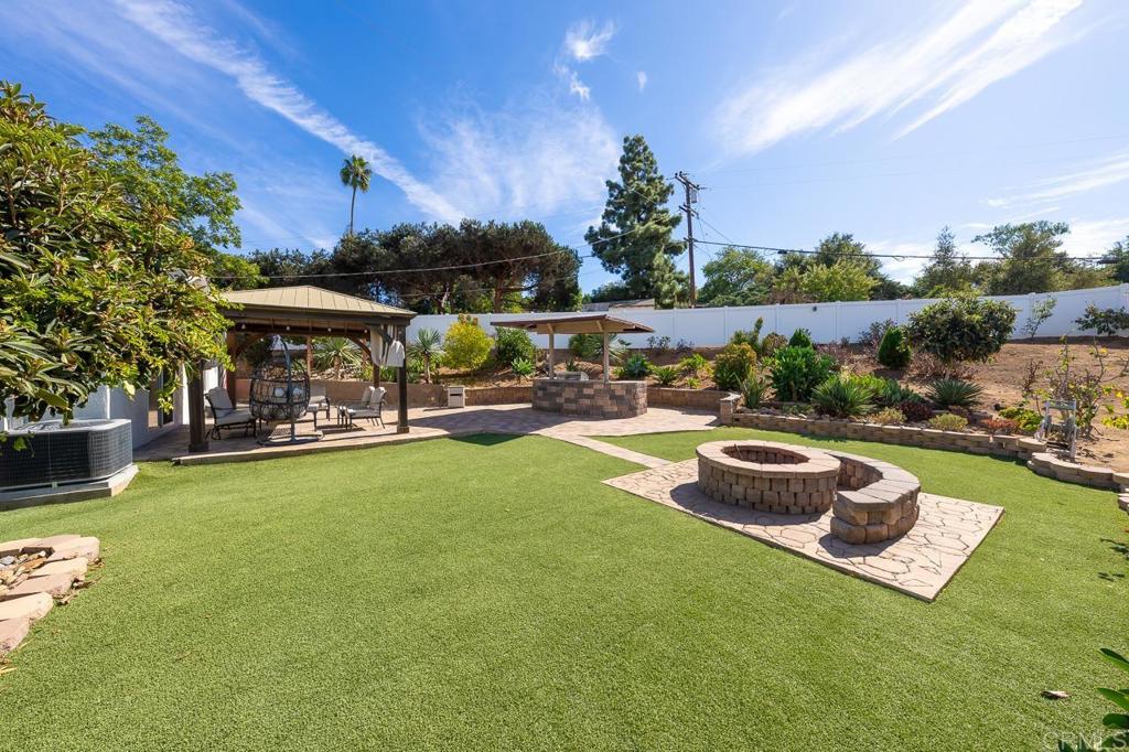 1661 Grove Road El Cajon, CA 92020 - Photo 1 of 44 a view of a swimming pool and lounge chairs in back yard of the house