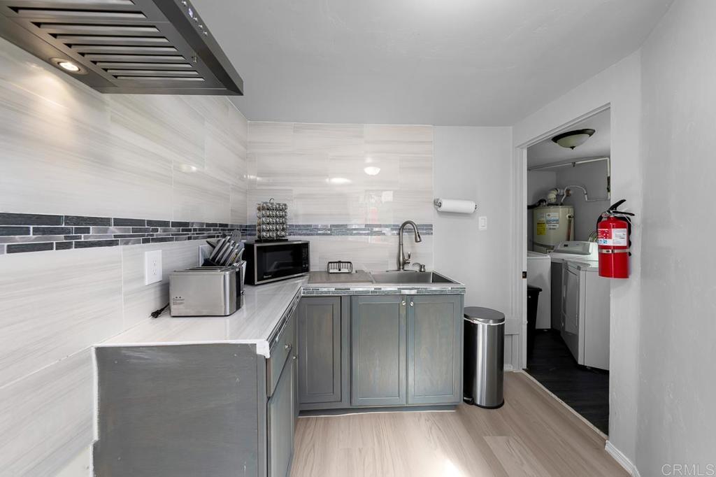 1661 Grove Road El Cajon, CA 92020 - Photo 16 of 44 a kitchen with stainless steel appliances granite countertop a refrigerator and a stove top oven