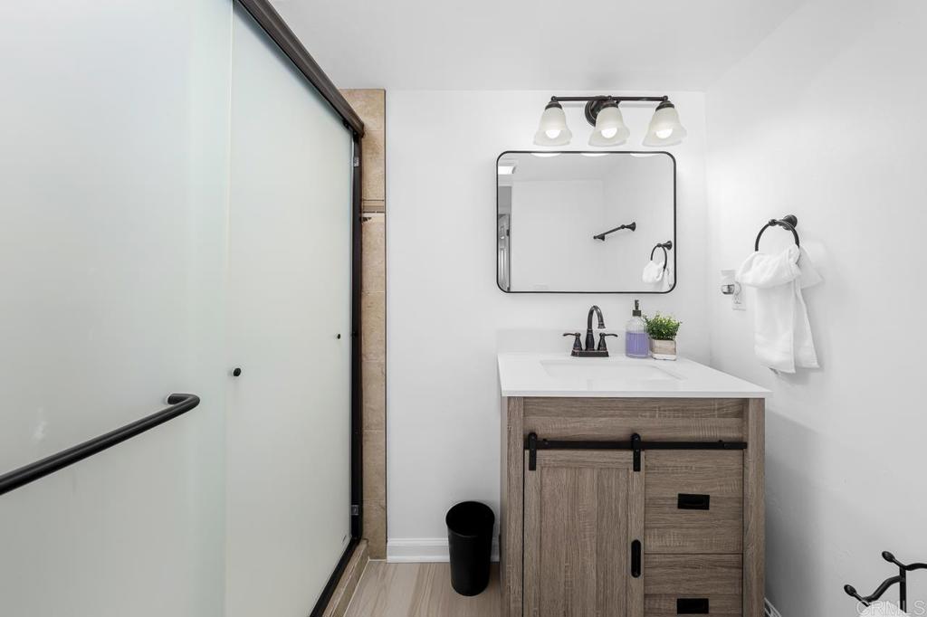 1661 Grove Road El Cajon, CA 92020 - Photo 21 of 44 a bathroom with a sink vanity and mirror