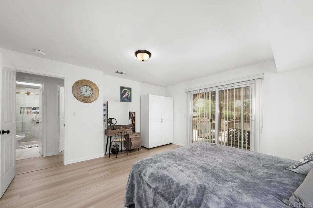 1661 Grove Road El Cajon, CA 92020 - Photo 23 of 44 a spacious bedroom with a bed and a large window