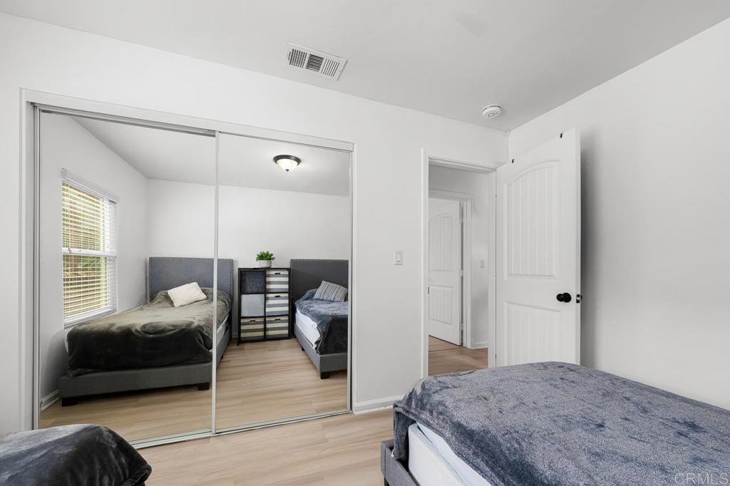 1661 Grove Road El Cajon, CA 92020 - Photo 26 of 44 a bedroom with a bed and wooden floor