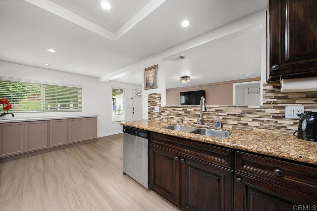 1661 Grove Road El Cajon, CA 92020 - Photo 4 of 44 a kitchen with lots of counter top space and wooden floor