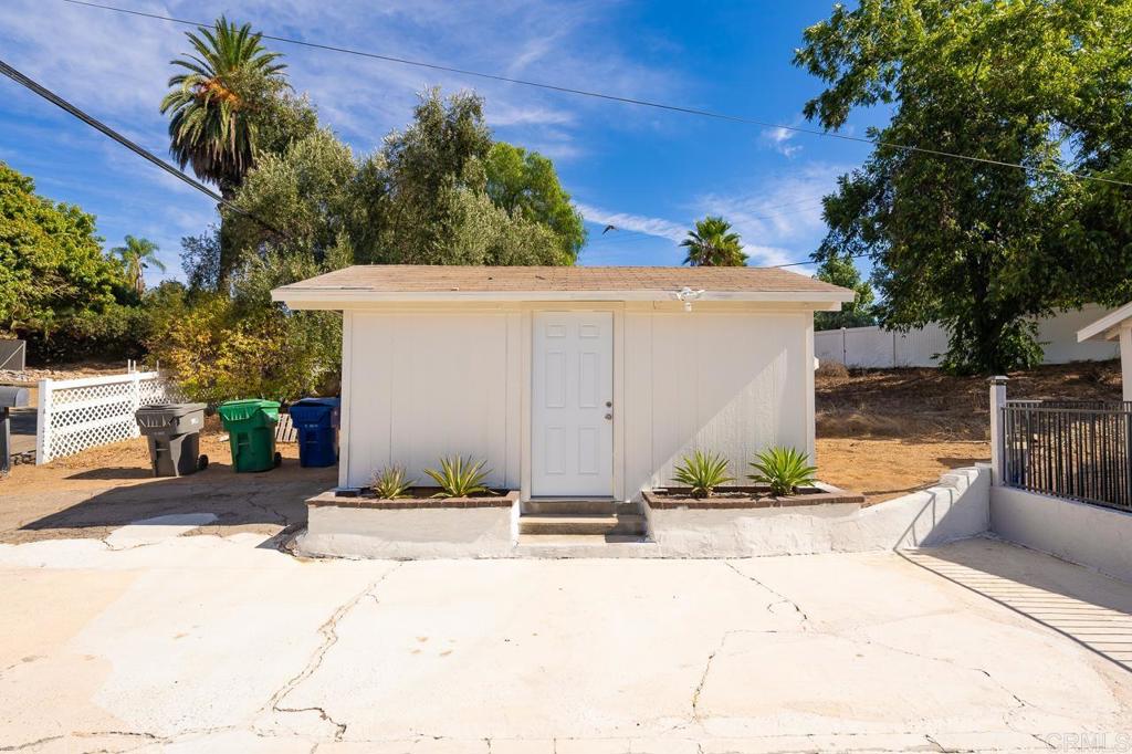 1661 Grove Road El Cajon, CA 92020 - Photo 43 of 44 a view of a house with potted plants and a large tree