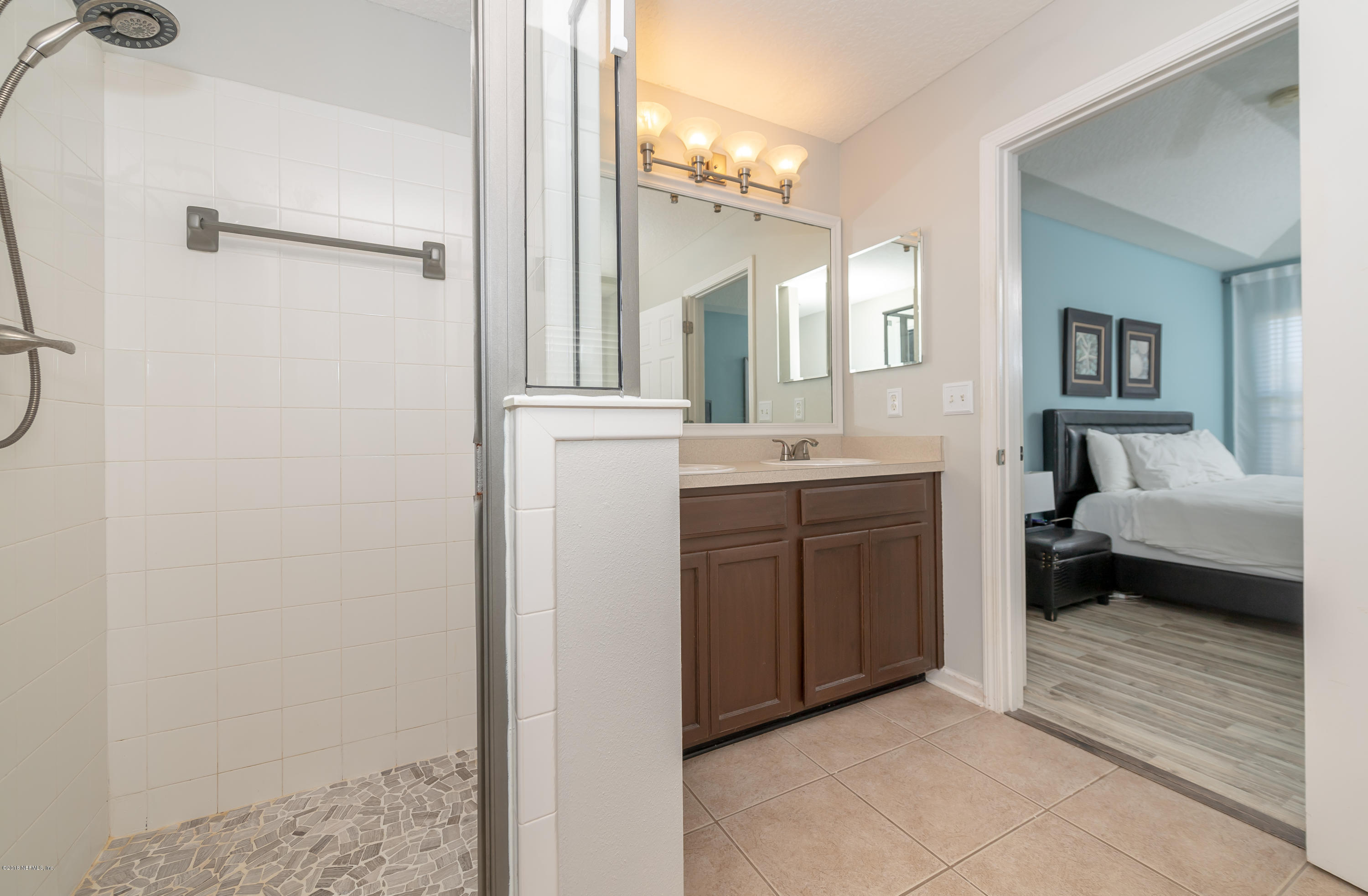 1565 Timber Trace Drive St. Augustine, FL 32092 - Photo 11 of 21 a en suite bathroom with a sink a mirror and a shower