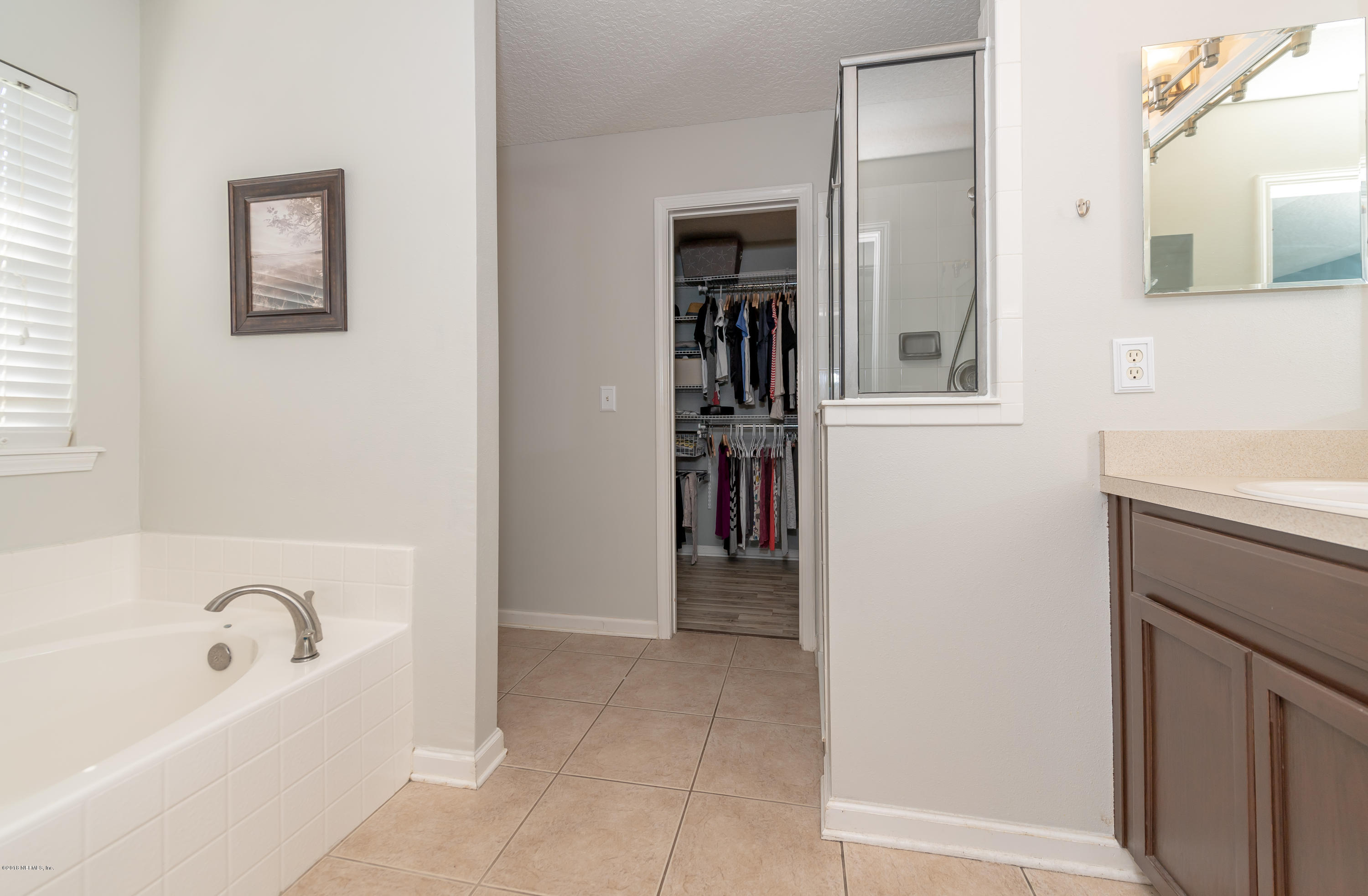 1565 Timber Trace Drive St. Augustine, FL 32092 - Photo 12 of 21 a bathroom with a bathtub and a sink