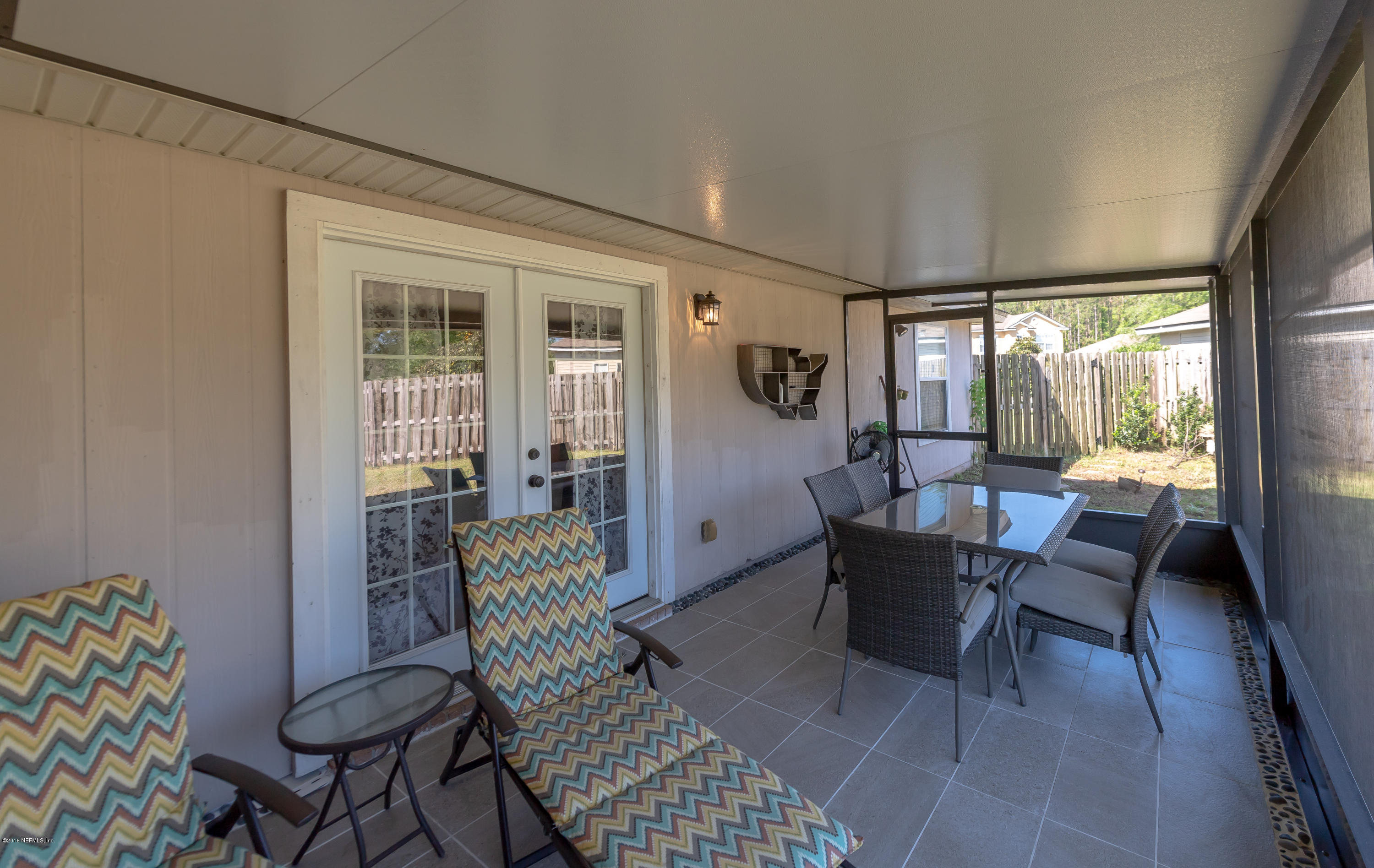 1565 Timber Trace Drive St. Augustine, FL 32092 - Photo 18 of 21 a living room with furniture and a floor to ceiling window