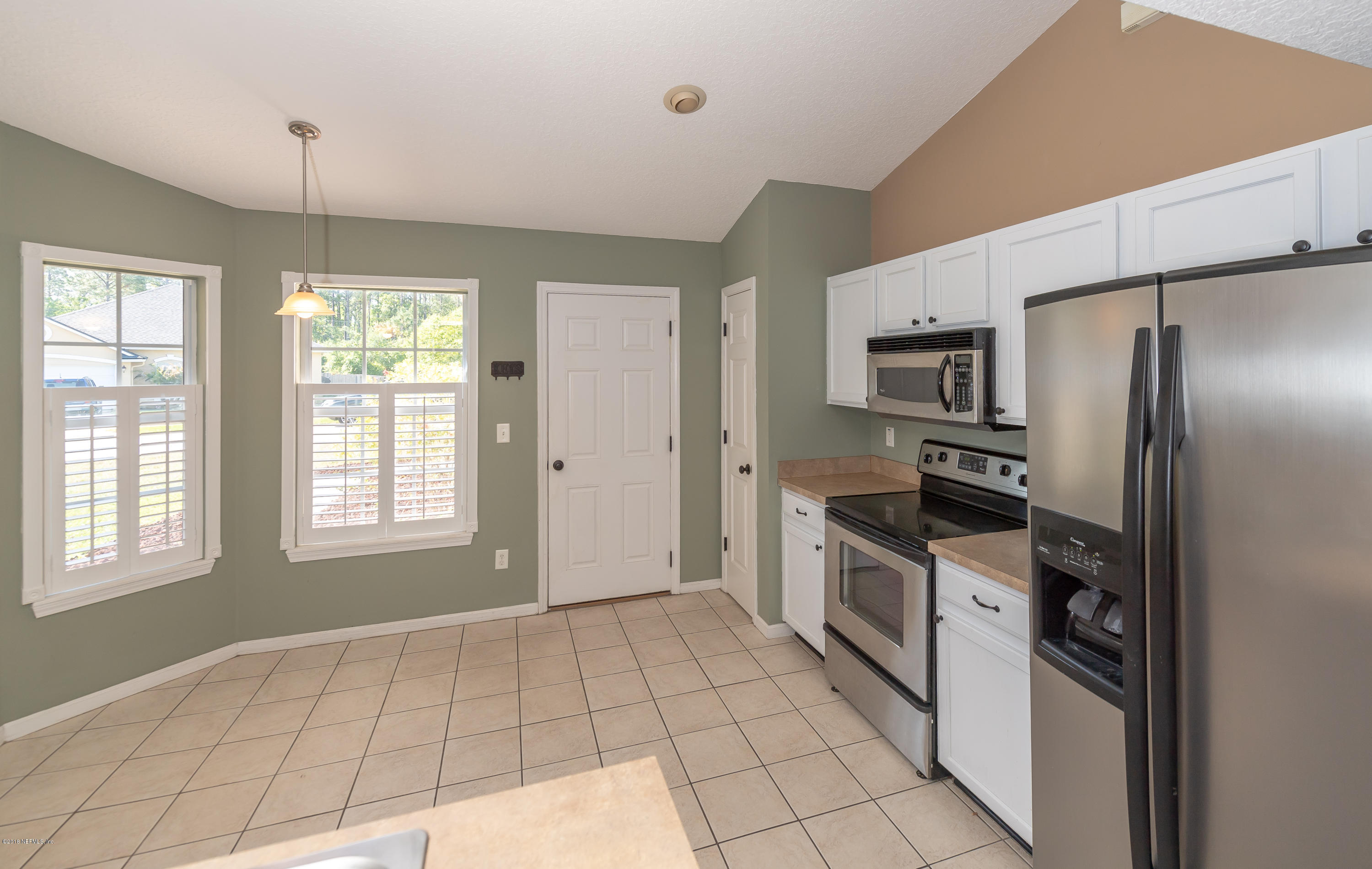 1565 Timber Trace Drive St. Augustine, FL 32092 - Photo 6 of 21 a kitchen with stainless steel appliances granite countertop a refrigerator a stove a sink dishwasher and a refrigerator