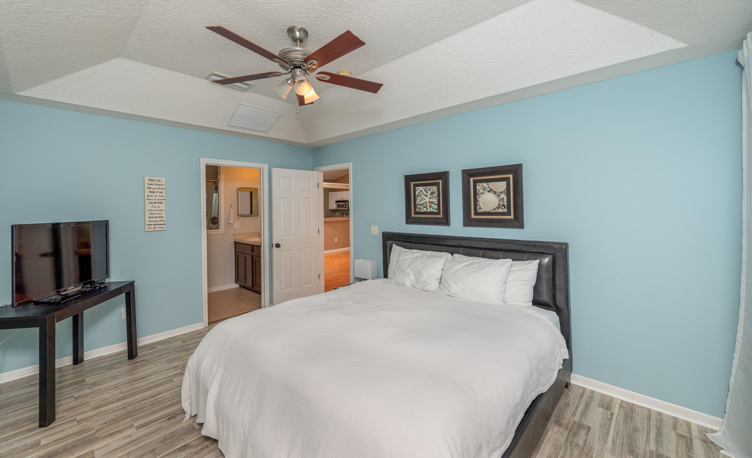 1565 Timber Trace Drive St. Augustine, FL 32092 - Photo 8 of 21 a bedroom with a large bed and a flat tv screen on dresser
