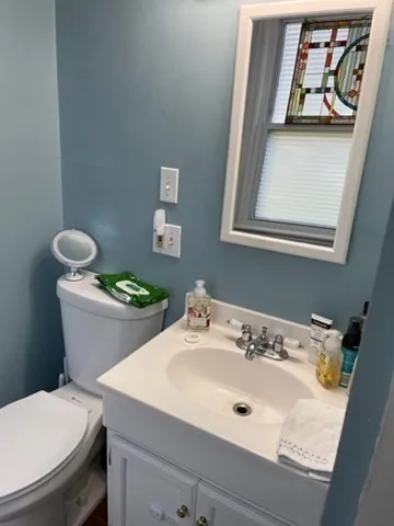 a bathroom with a toilet sink and mirror