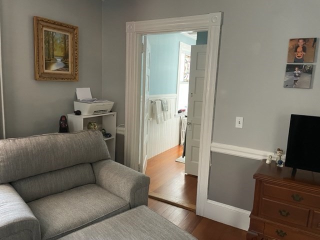 509 Bay Road, Unit 1L Hamilton, MA 01982 - Photo 6 of 10 a living room with furniture and a flat screen tv