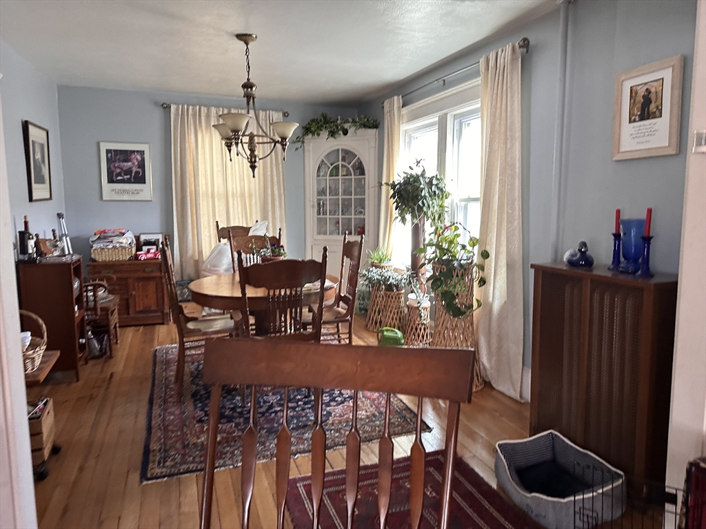 445 Chicopee Street Chicopee, MA 01013 - Photo 11 of 14 a view of a dining room and livingroom with furniture wooden floor a chandelier