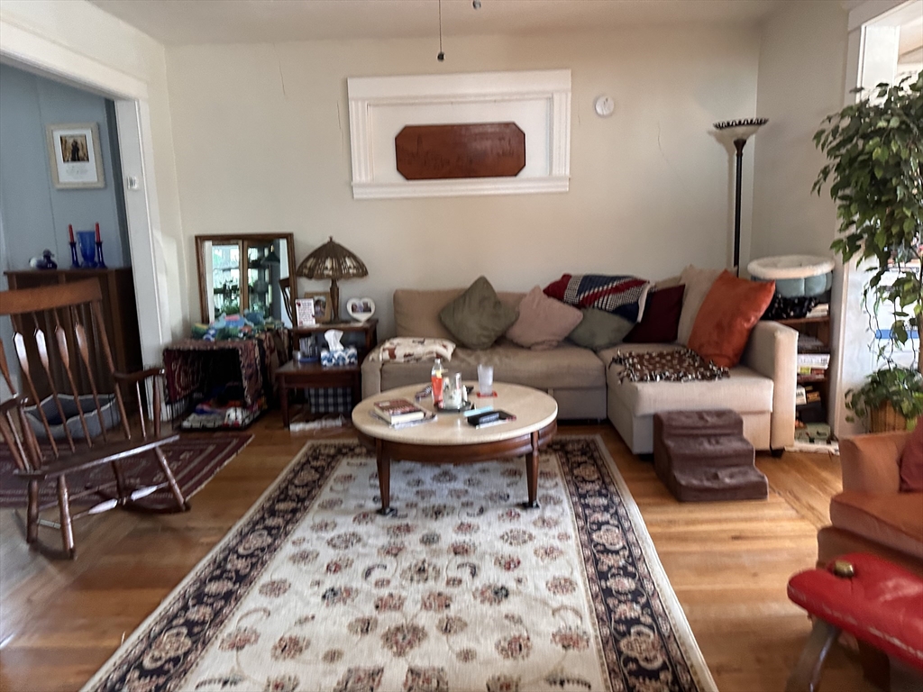 445 Chicopee Street Chicopee, MA 01013 - Photo 12 of 14 a living room with furniture and a rug